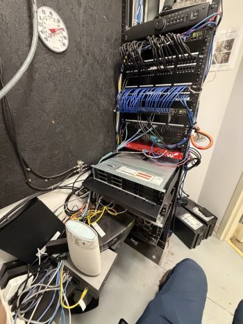 Disorganized server rack and cabling before an IT infrastructure upgrade for Construction client in Neptune, NJ